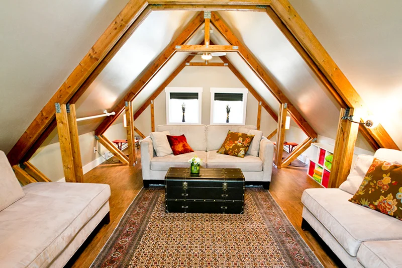 Attic living room with wooden beams and cozy furniture Attic living room with wooden beams and cozy furniture