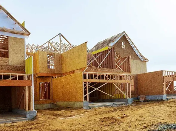 Construction site of partially built wooden houses