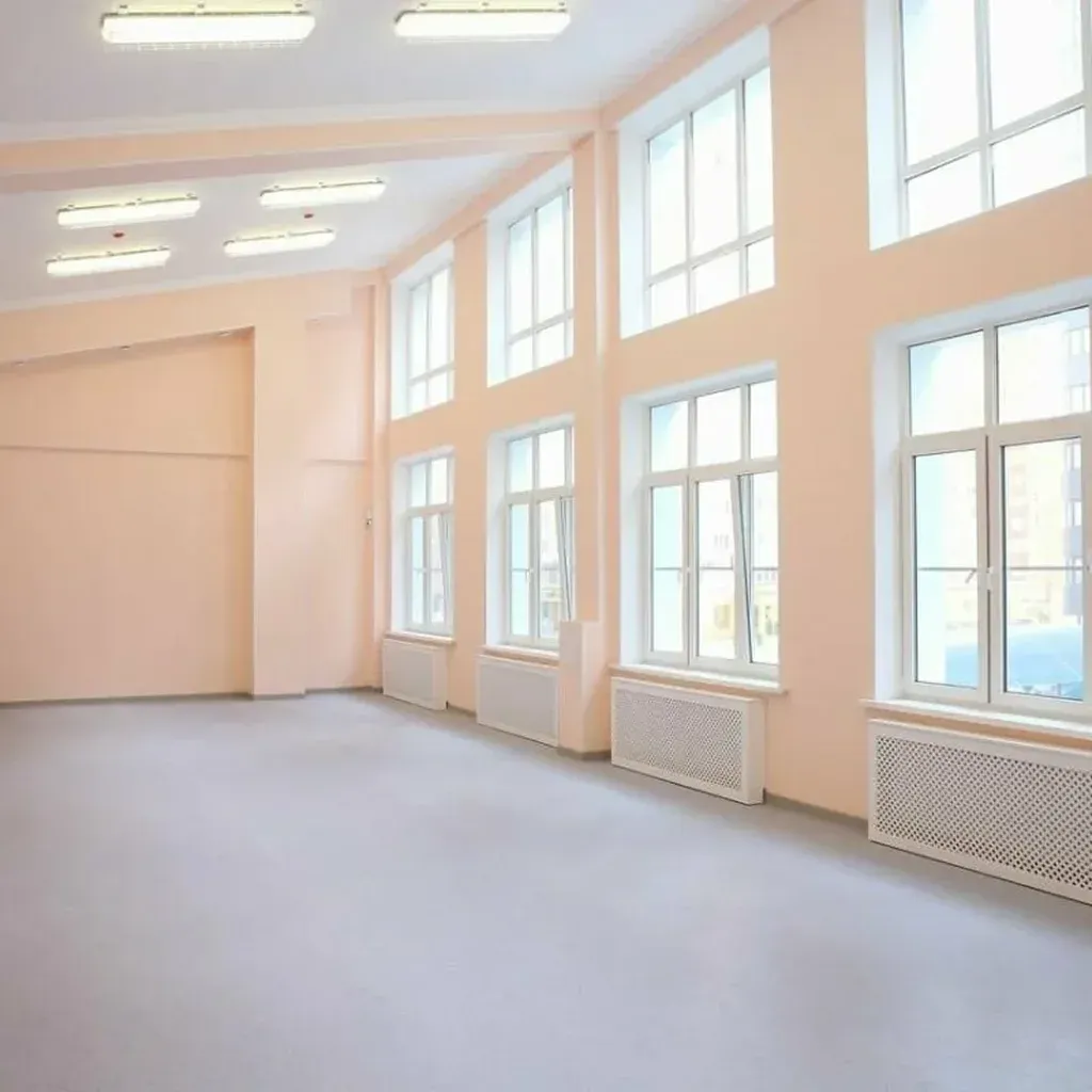 Empty room with large windows and pale pink walls Empty room with large windows and pale pink walls