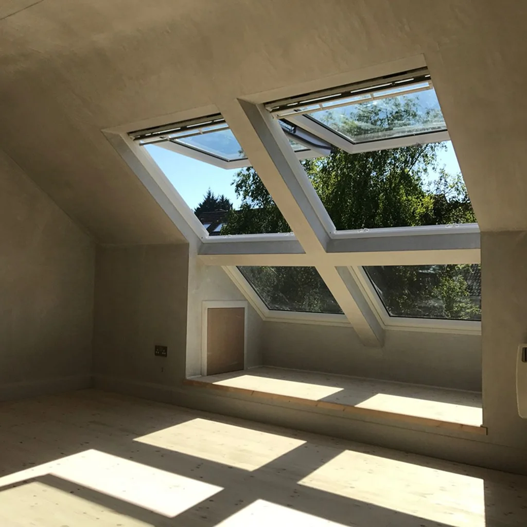 Room with slanted skylights and wooden floor Room with slanted skylights and wooden floor