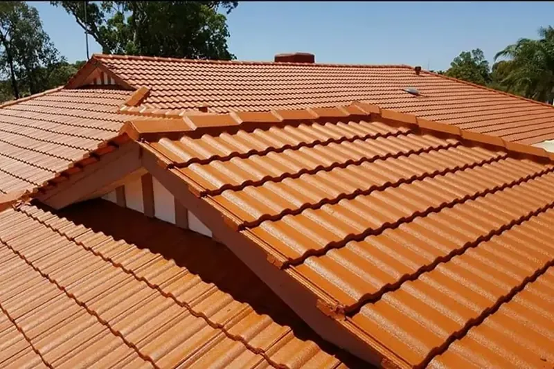 Tile roof with orange-colored tiles and multiple slopes