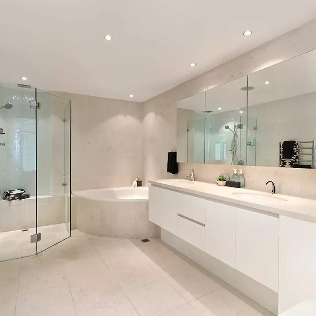 bathroom featuring a glass shower oval tub double sink vanity bathroom featuring a glass shower, oval tub, double sink vanity