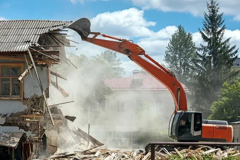 construction excavator demolishing a building construction excavator demolishing a building