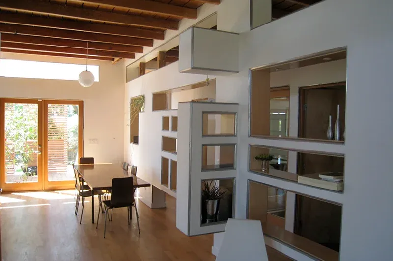 dining area with a wooden table, sleek chairs